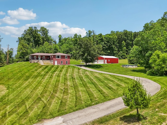 15586 Stump Run, Laurelville, OH 43135 - view of grassy yard with driveway, a garage, and an outdoor structure