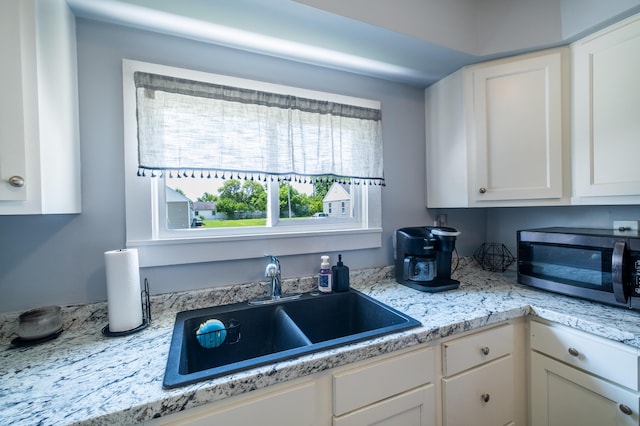 647 Harrison St, Washington Court House, OH 43160 - kitchen featuring stainless steel microwave, light countertops, and white cabinets