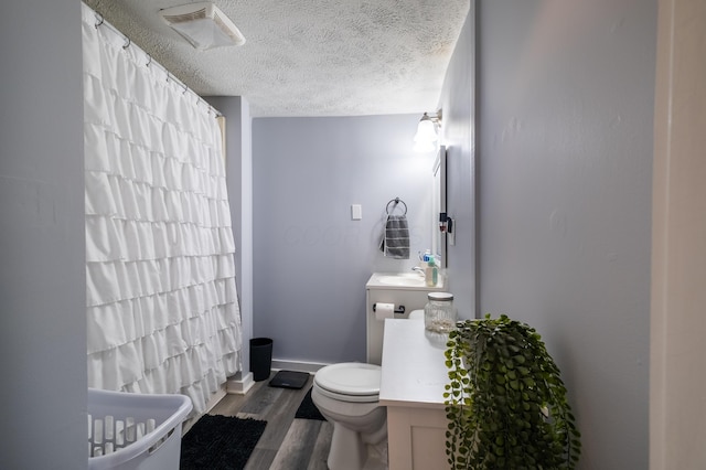647 Harrison St, Washington Court House, OH 43160 - full bath with vanity, wood finished floors, a shower with shower curtain, and a textured ceiling