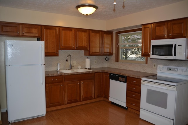 463 Denwood Dr S, Gahanna, OH 43230 - kitchen with white appliances, brown cabinets, tasteful backsplash, and a textured ceiling