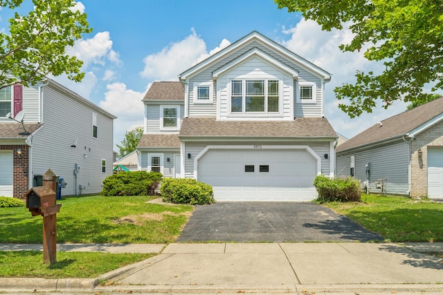 6872 Spring Bloom Dr, Canal Winchester, OH 43110 - view of front facade featuring asphalt driveway, an attached garage, a front yard, and a shingled roof