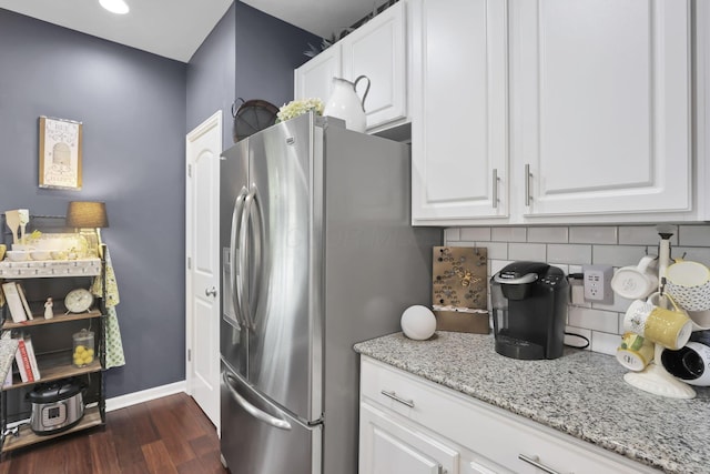 6169 Jennis Rd, Westerville, OH 43081 - kitchen with stainless steel refrigerator with ice dispenser, tasteful backsplash, white cabinets, dark wood-style floors, and light stone countertops