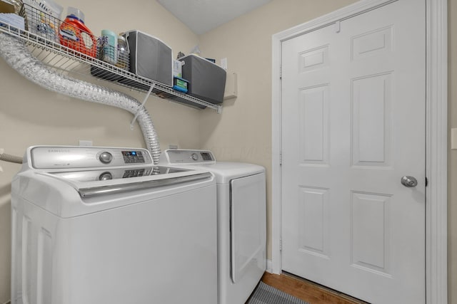 6277 Hudson Reserve Way, Westerville, OH 43081 - laundry area featuring washing machine and clothes dryer and wood finished floors