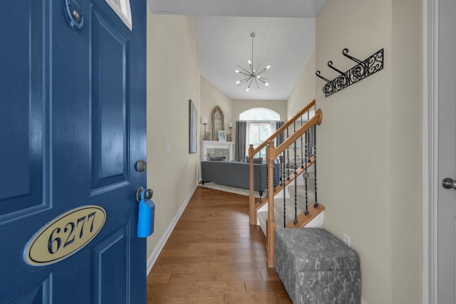 6277 Hudson Reserve Way, Westerville, OH 43081 - foyer entrance featuring a chandelier, stairway, and wood finished floors