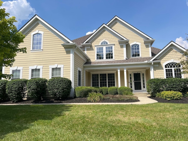 8730 Swisher Creek Xing, New Albany, OH 43054 - view of front facade with a front yard, a shingled roof, and covered porch