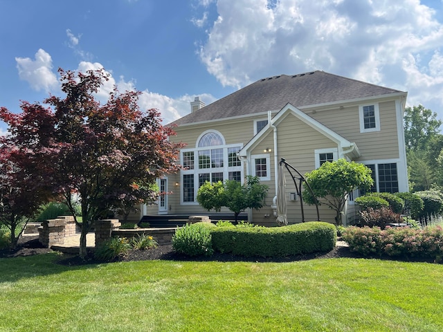 8730 Swisher Creek Xing, New Albany, OH 43054 - rear view of property featuring a lawn, a chimney, and a shingled roof