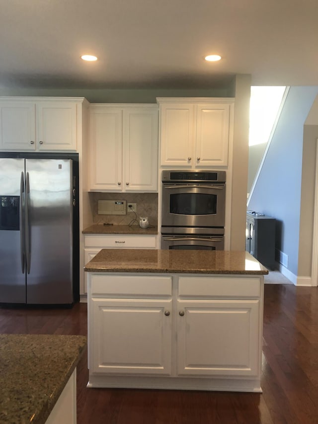 8730 Swisher Creek Xing, New Albany, OH 43054 - kitchen featuring appliances with stainless steel finishes, white cabinets, dark stone counters, dark wood finished floors, and recessed lighting