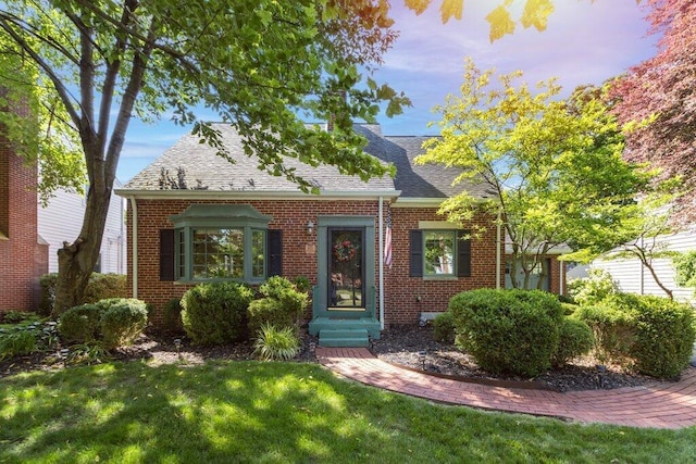 1855 Suffolk Rd, Columbus, OH 43221 - cape cod house with brick siding, a front yard, and roof with shingles