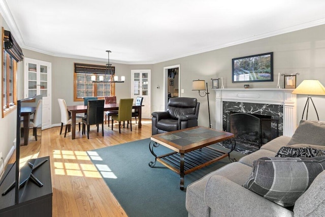 1855 Suffolk Rd, Columbus, OH 43221 - living room featuring wood finished floors, a chandelier, a premium fireplace, and ornamental molding