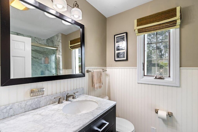 1855 Suffolk Rd, Columbus, OH 43221 - full bath with a shower stall, wainscoting, vanity, and healthy amount of natural light