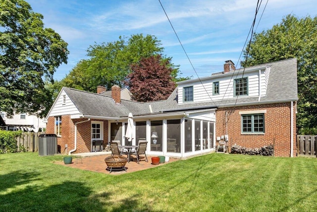 1855 Suffolk Rd, Columbus, OH 43221 - back of property with brick siding, a fire pit, a sunroom, a patio area, and a chimney