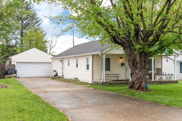 508 Carolyn Rd, Washington Court House, OH 43160 - view of front facade featuring covered porch, an outdoor structure, a detached garage, a front yard, and a shingled roof