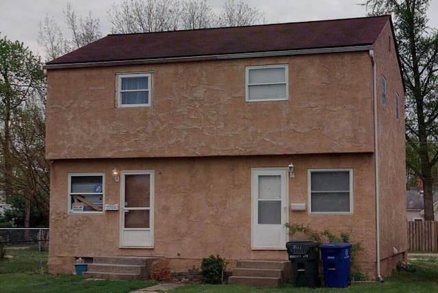 2169 Amherst Ave, Columbus, OH 43223 - rear view of property featuring entry steps, stucco siding, and a shingled roof