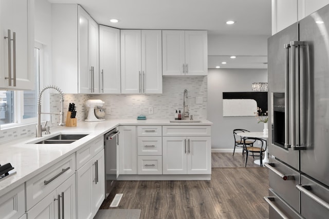 50 S Kellner Rd, Columbus, OH 43209 - kitchen with appliances with stainless steel finishes, white cabinetry, decorative backsplash, dark wood-style flooring, and recessed lighting