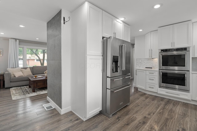 50 S Kellner Rd, Columbus, OH 43209 - kitchen with appliances with stainless steel finishes, dark wood-type flooring, white cabinetry, recessed lighting, and backsplash