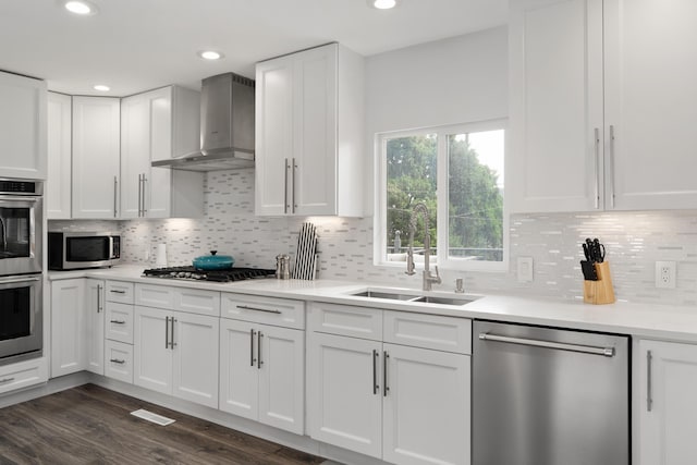 50 S Kellner Rd, Columbus, OH 43209 - kitchen with stainless steel appliances, wall chimney exhaust hood, white cabinets, decorative backsplash, and recessed lighting