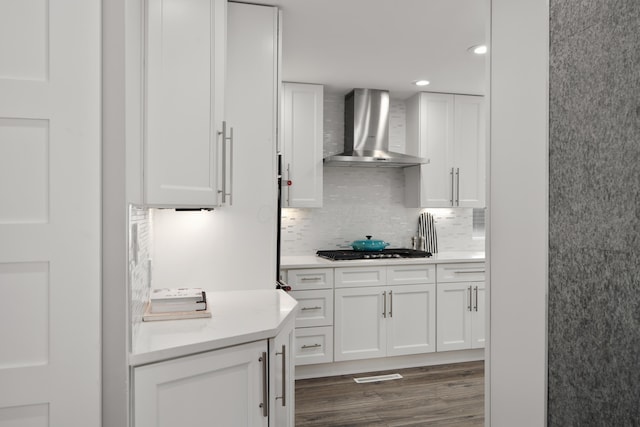 50 S Kellner Rd, Columbus, OH 43209 - kitchen featuring wall chimney range hood, light countertops, white cabinetry, backsplash, and recessed lighting
