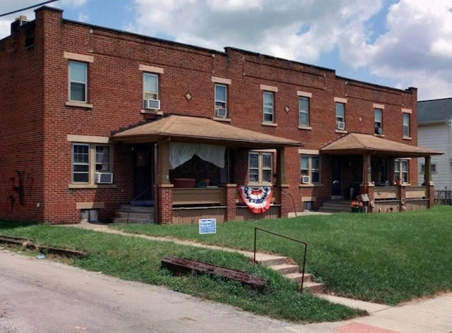 540 S Richardson Ave, Columbus, OH 43204 - view of front of house featuring brick siding, covered porch, a front yard, and cooling unit