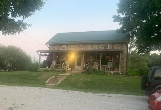 15326 Hartford Rd, Sunbury, OH 43074 - view of front of house featuring covered porch and a front yard