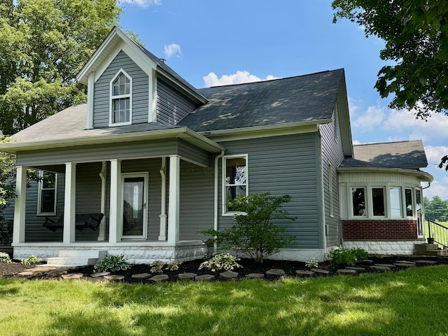 4640 Chillicothe Lancaster Rd SW, Lancaster, OH 43130 - view of side of home with covered porch, a shingled roof, and a lawn