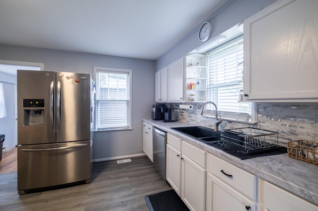 1221 S Main St, Washington Court House, OH 43160 - kitchen featuring stainless steel appliances, white cabinetry, and tasteful backsplash