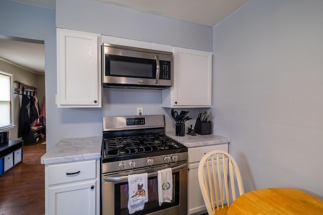 1221 S Main St, Washington Court House, OH 43160 - kitchen with stainless steel appliances, light countertops, white cabinets, and dark wood-style floors