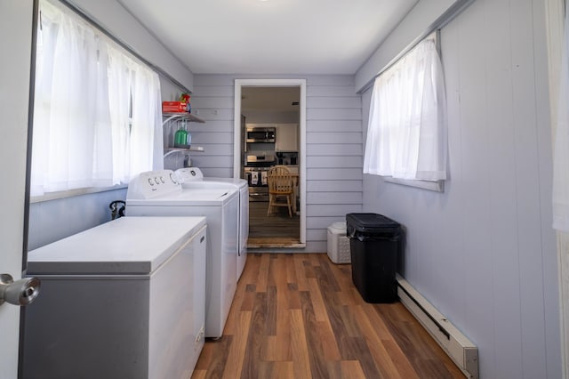1221 S Main St, Washington Court House, OH 43160 - laundry area with baseboard heating, washing machine and clothes dryer, and wood finished floors