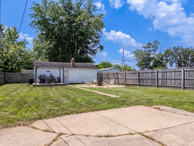 1221 S Main St, Washington Court House, OH 43160 - fenced backyard featuring a fire pit, a patio, and a deck