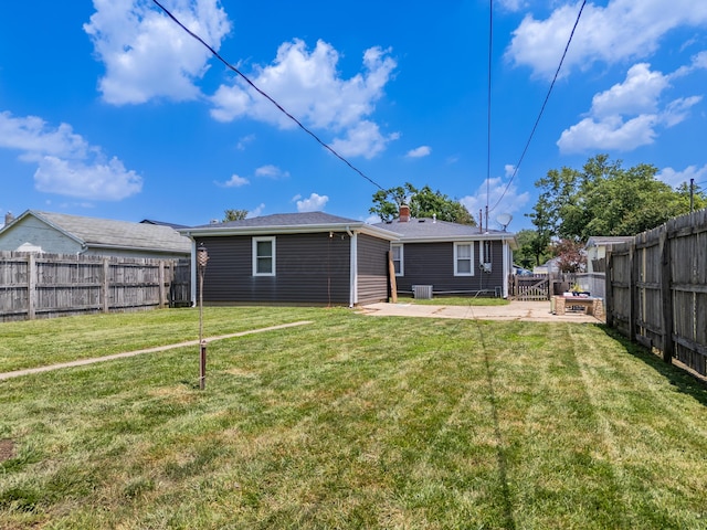 1221 S Main St, Washington Court House, OH 43160 - rear view of house with a fenced backyard, a patio, and a chimney