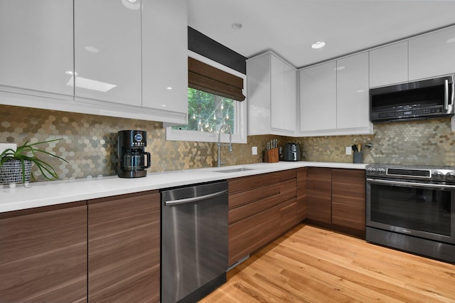 160 Wildwood Dr, Granville, OH 43023 - kitchen with appliances with stainless steel finishes, modern cabinets, white cabinetry, and light countertops