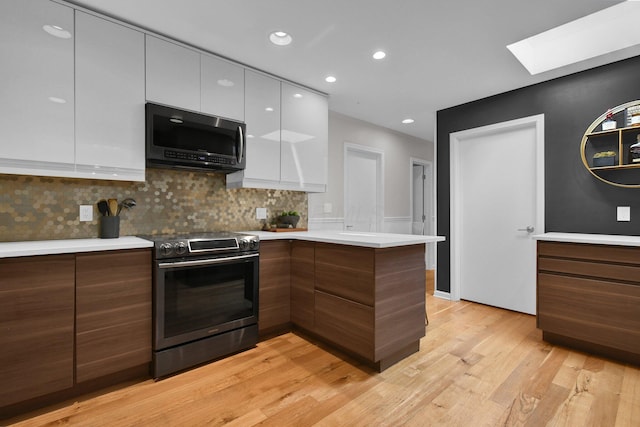 160 Wildwood Dr, Granville, OH 43023 - kitchen with appliances with stainless steel finishes, modern cabinets, a skylight, light countertops, and light wood finished floors