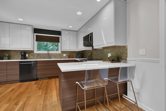 160 Wildwood Dr, Granville, OH 43023 - kitchen featuring dishwasher, modern cabinets, a peninsula, white cabinets, and recessed lighting