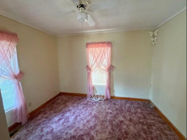 498 E Mark St, Marion, OH 43302 - empty room with ornamental molding, ceiling fan, and carpet floors