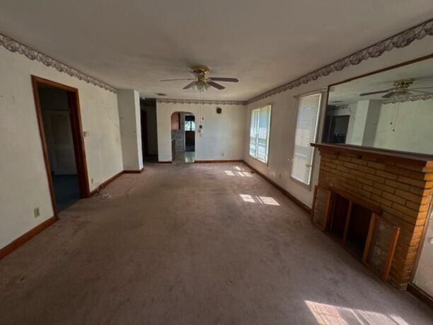498 E Mark St, Marion, OH 43302 - unfurnished living room featuring a ceiling fan, arched walkways, and carpet flooring