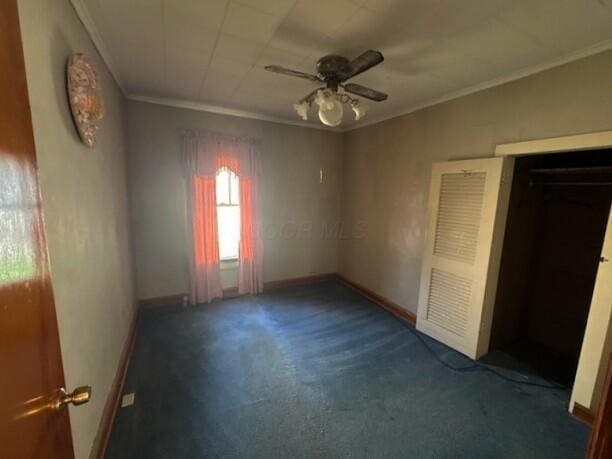 498 E Mark St, Marion, OH 43302 - unfurnished bedroom featuring ornamental molding, carpet flooring, and ceiling fan
