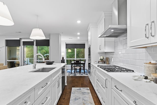 105 N Riverview St Unit 218, Dublin, OH 43017 - kitchen with wall chimney exhaust hood, appliances with stainless steel finishes, decorative backsplash, white cabinetry, and dark wood-style flooring