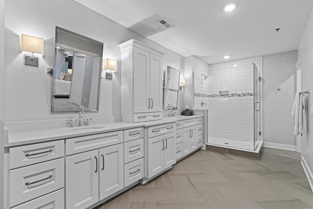 105 N Riverview St Unit 218, Dublin, OH 43017 - ensuite bathroom featuring double vanity, a shower stall, and recessed lighting