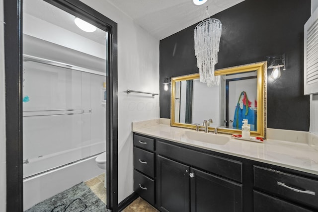 1208 Ashland Ave, Columbus, OH 43212 - bathroom featuring a chandelier, vanity, bath / shower combo with glass door, and stone finish flooring