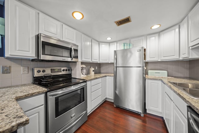 1208 Ashland Ave, Columbus, OH 43212 - kitchen featuring appliances with stainless steel finishes, tasteful backsplash, white cabinets, and recessed lighting