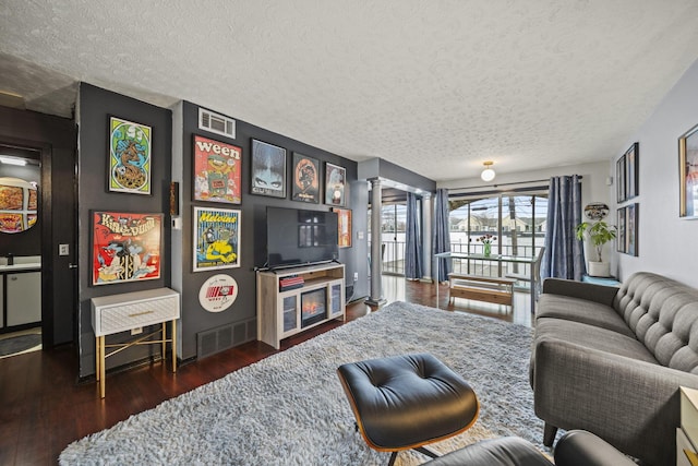 1208 Ashland Ave, Columbus, OH 43212 - living area with a textured ceiling and dark wood-type flooring