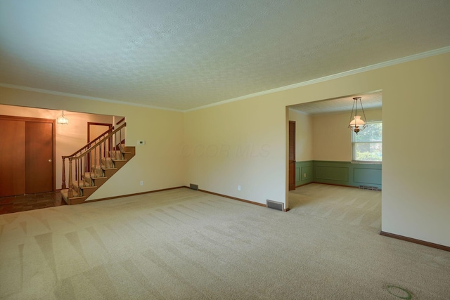 8899 Chevington Ct, Pickerington, OH 43147 - unfurnished living room with stairs, carpet flooring, a textured ceiling, and ornamental molding