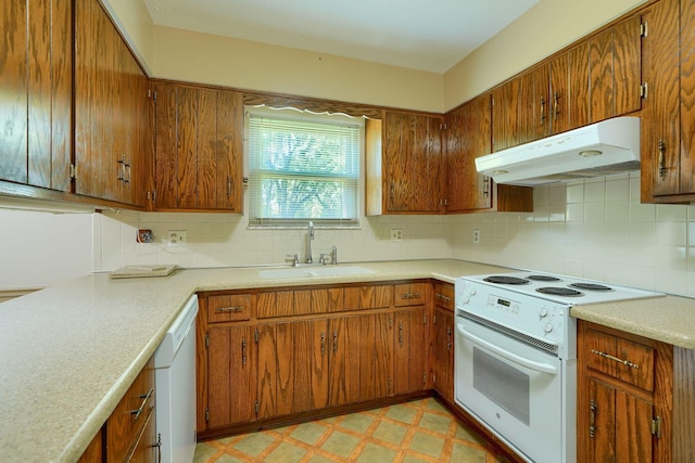 8899 Chevington Ct, Pickerington, OH 43147 - kitchen featuring white appliances, under cabinet range hood, brown cabinetry, light countertops, and backsplash