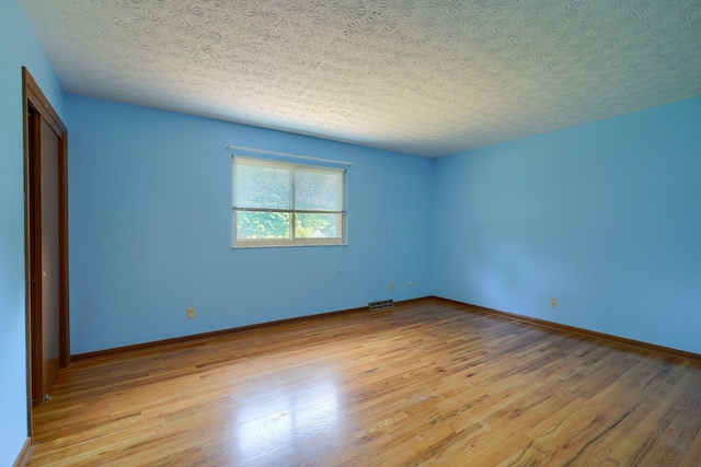 8899 Chevington Ct, Pickerington, OH 43147 - empty room featuring light wood-style flooring and a textured ceiling