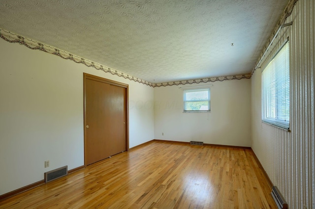 8899 Chevington Ct, Pickerington, OH 43147 - empty room with light wood-style floors and a textured ceiling