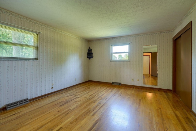 8899 Chevington Ct, Pickerington, OH 43147 - spare room with hardwood / wood-style floors and a textured ceiling
