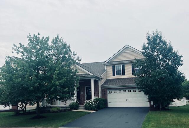 5985 Mcjessy Dr, Westerville, OH 43081 - view of front of house featuring a garage and asphalt driveway