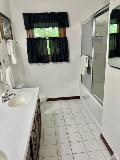 171 Ginder Rd NE, Lancaster, OH 43130 - full bathroom featuring vanity, shower / bath combination with glass door, and tile patterned floors