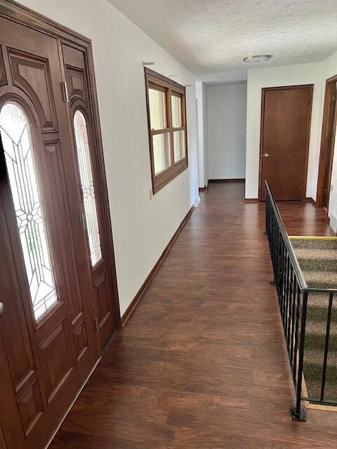 171 Ginder Rd NE, Lancaster, OH 43130 - corridor with plenty of natural light, dark wood-type flooring, and a textured ceiling