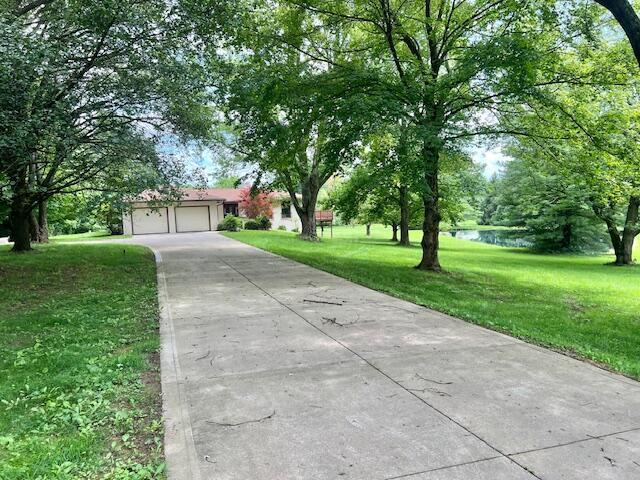 171 Ginder Rd NE, Lancaster, OH 43130 - view of front facade with a garage, a front yard, and concrete driveway