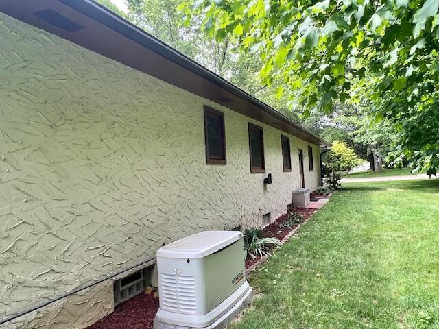 171 Ginder Rd NE, Lancaster, OH 43130 - view of property exterior with a lawn and stucco siding